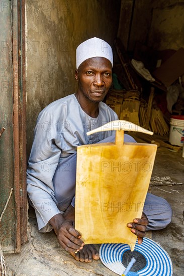 Man carving the Quoran on a wooden board