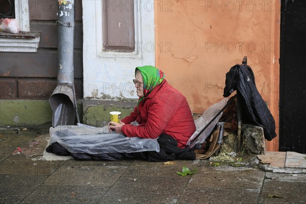 Old woman sitting on the floor