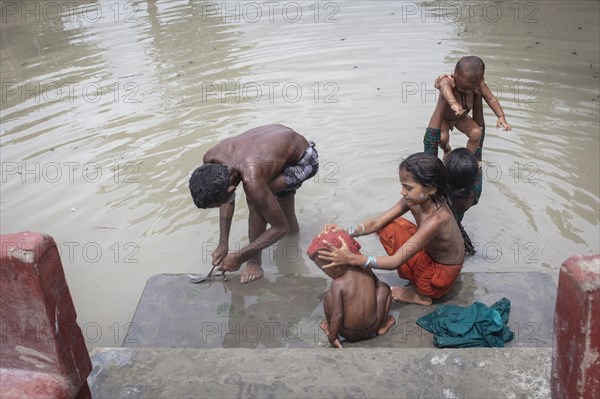 A man with his four children taking a bath