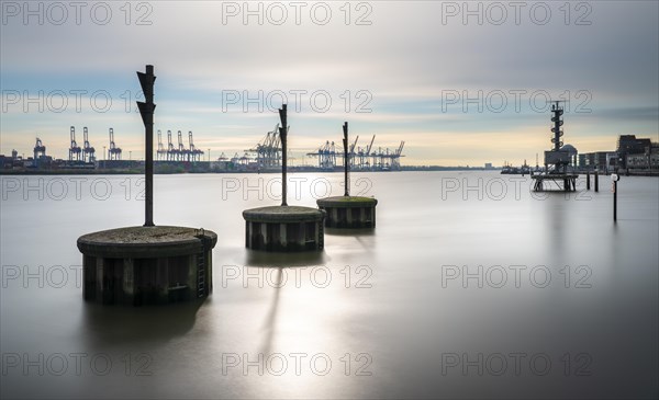 Long exposure of concrete bollards in the river Elbe at the port of Hamburg