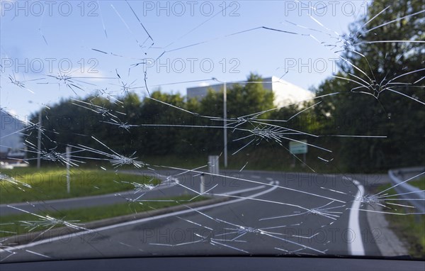 Shattered windscreen due to hailstones on a car