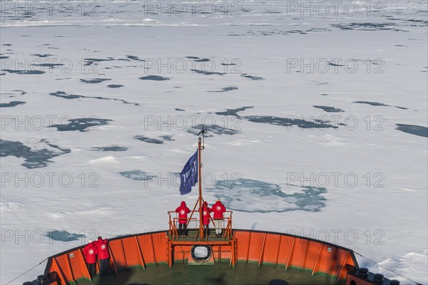 Tourists watching the ice breaking on board of an icebreaker