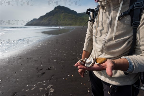 Woman with shells in hand