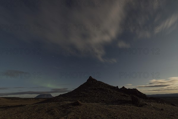 Faint northern lights (Aurora Borealis) and star trails