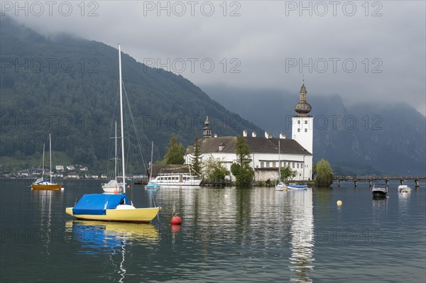 Orth Castle on Lake Traun in Gmunden and boats in the water