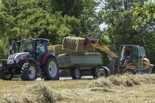 Hay bales being loaded