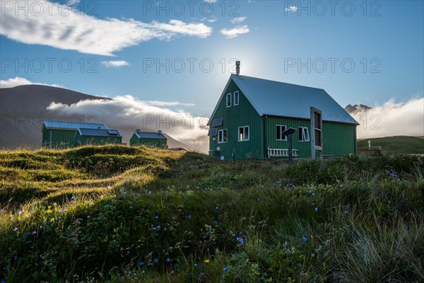 Huts of the Icelandic Hiking Club in the backlight