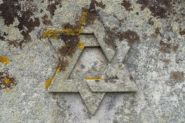 Weathered Star of David on a gravestone