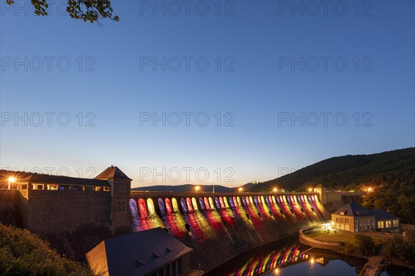 Illuminated dam wall in the evening twilight