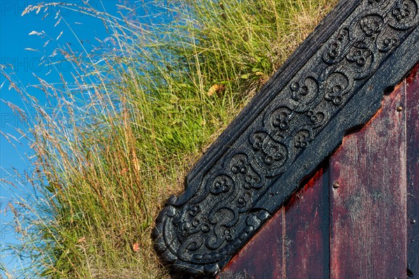 Panel and grass roof decorated with carvings