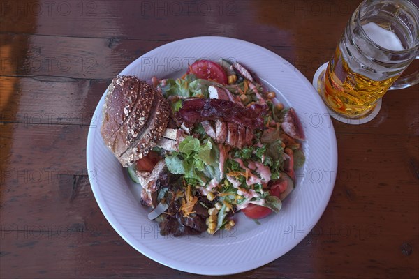 Salad with roasted turkey strips served in a garden restaurant