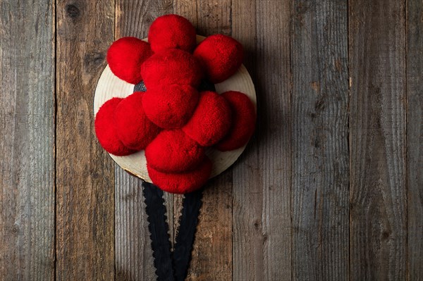 Original Black Forest Bollen hat in front of rustic wooden wall