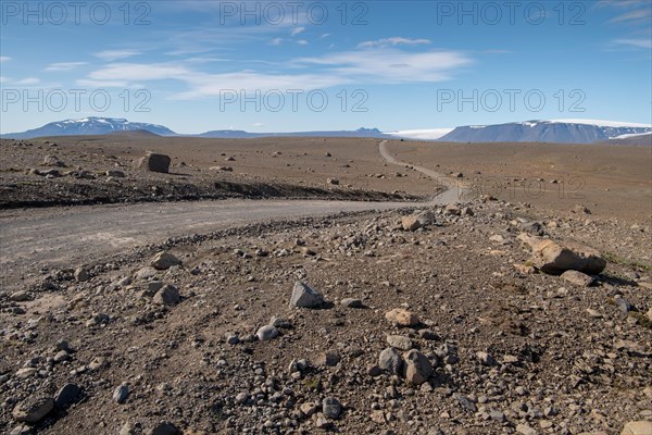 Lonely gravel road through volcanic landscape