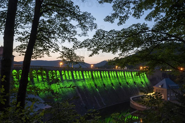 Illuminated dam wall in the evening twilight