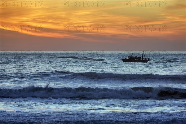 Fishing boat in the surf