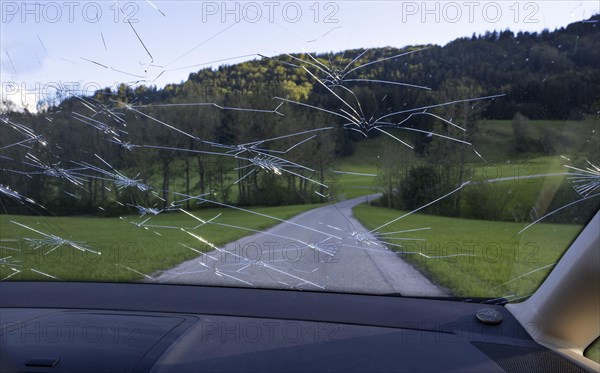 Shattered windscreen due to hailstones on a car