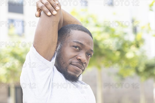 Young black man doing fitness in the summer of the city