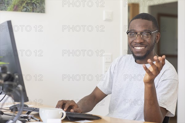 Young black man working at desk in office