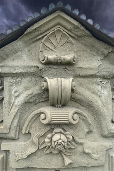 Ornaments and symbol of a rose on a gravestone