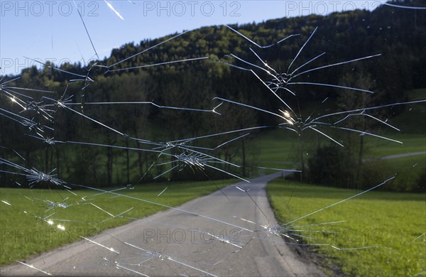 Shattered windscreen due to hailstones on a car