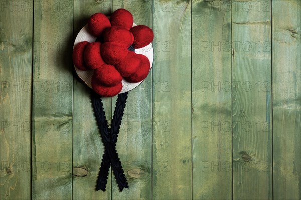 Original Black Forest Bollen hat in front of green wooden wall