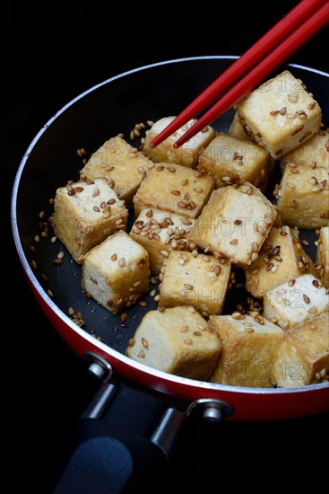 Fried tofu cubes in pan