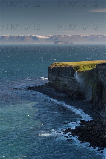 Waterfall falls over cliff and is blown away by wind