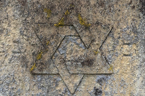 Weathered Star of David on a gravestone