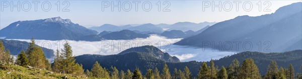 Hiker sitting on a bench and looking over the landscape