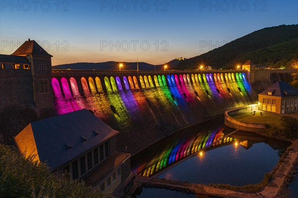 Illuminated dam wall in the evening twilight