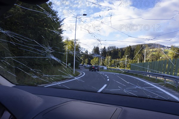 Shattered windscreen due to hailstones on a car