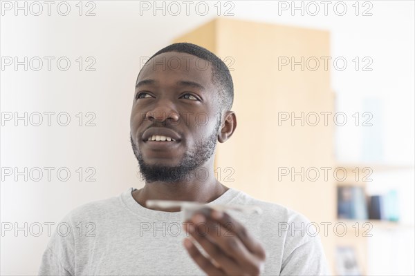 Young black man holding a product idea