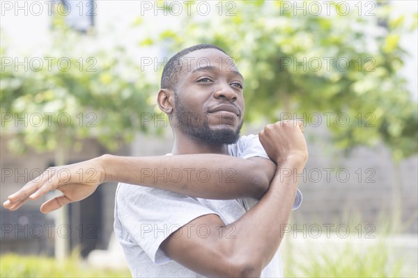 Young black man doing fitness in the summer of the city