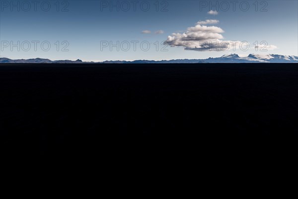 Clouds over lava desert