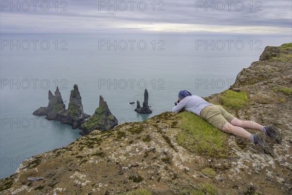 Woman photographing the Reynisdrangar