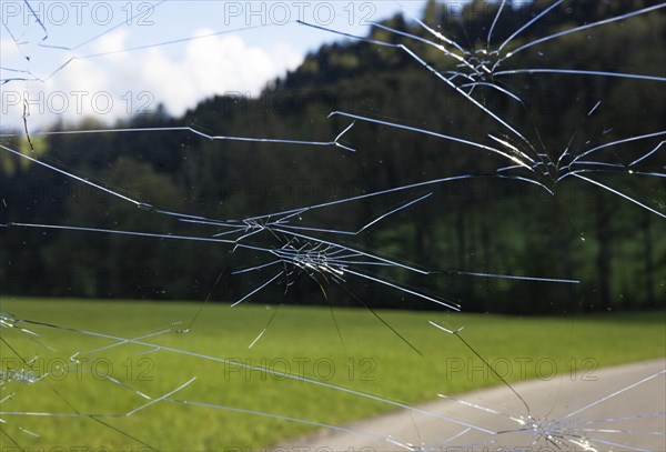 Shattered windscreen due to hailstones on a car