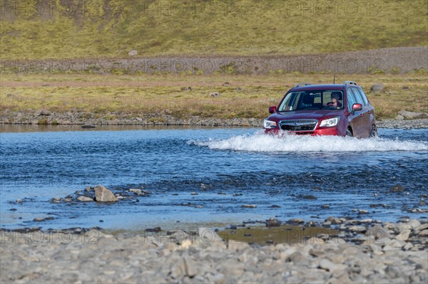 SUV driving through ford Geirlandsa river