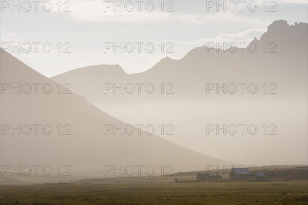 Cabins of the Icelandic Hiking Association in front of the mountain range Dyrfjoell