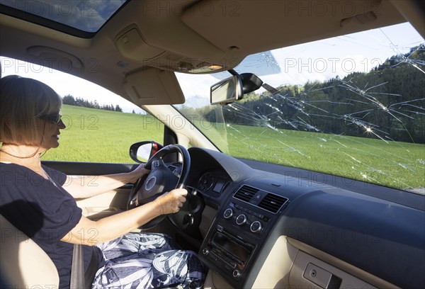 Shattered windscreen due to hailstones on a car