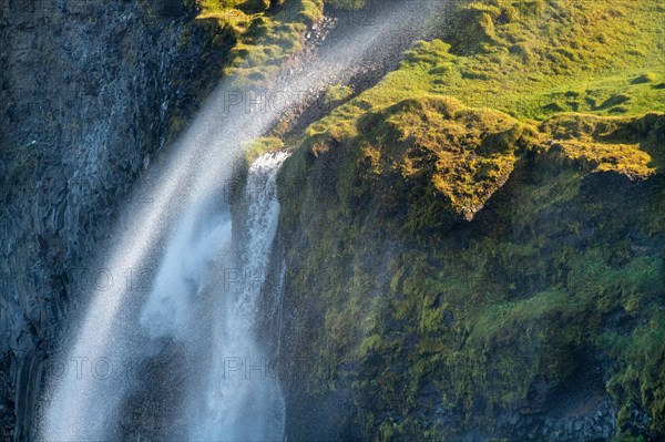 Waterfall falls over cliff and is blown away by wind