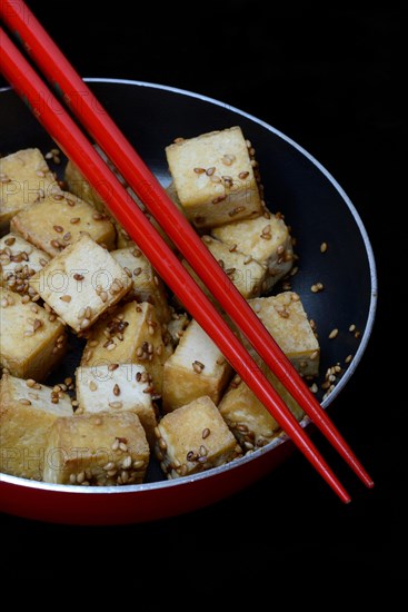 Fried tofu cubes in pan