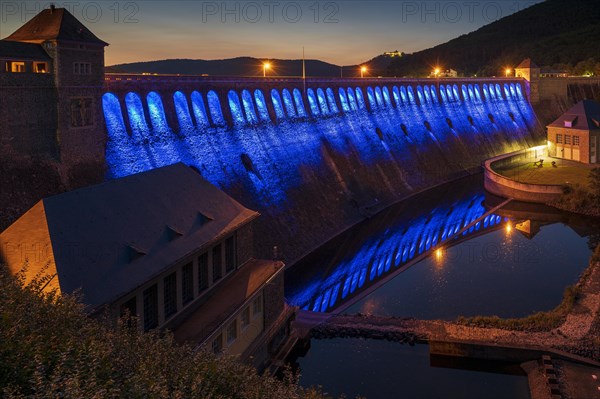 Illuminated dam wall in the evening twilight