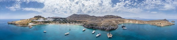Sailboats anchoring in front of Lindos