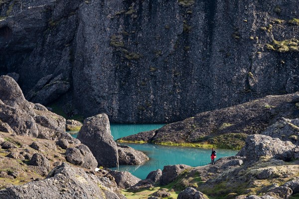 Woman standing in front of turquoise water pool