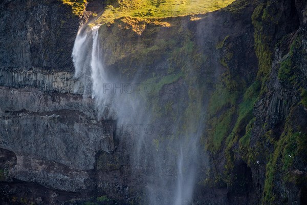 Waterfall falls over cliff and is blown away by wind