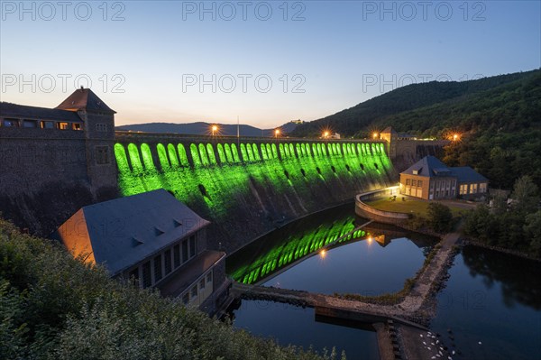 Illuminated dam wall in the evening twilight