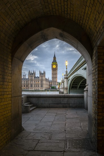 View through archway onto Westminster Bridge with Thames and Palace of Westminster