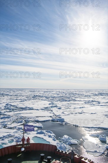 People enjoying the breaking ice on board of an icebreaker