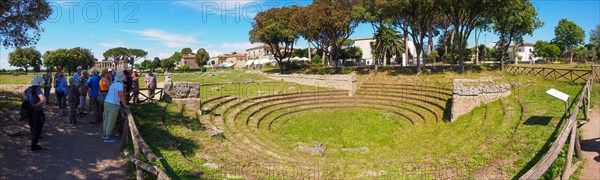 A tourist group visits the amphitheater of Paestum