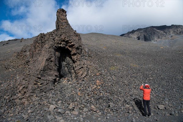 Tourist photographing volcanic vent at the table volcano Heroubreio or Herdubreid